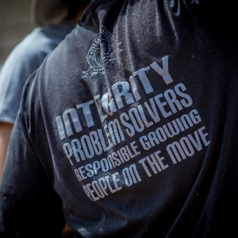 back of t-shirt with the text Integrity, Problem Solvers, Responsible Growing, People on the Move