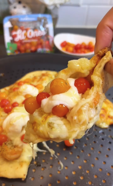 cheesy pizza slice with tomatoes