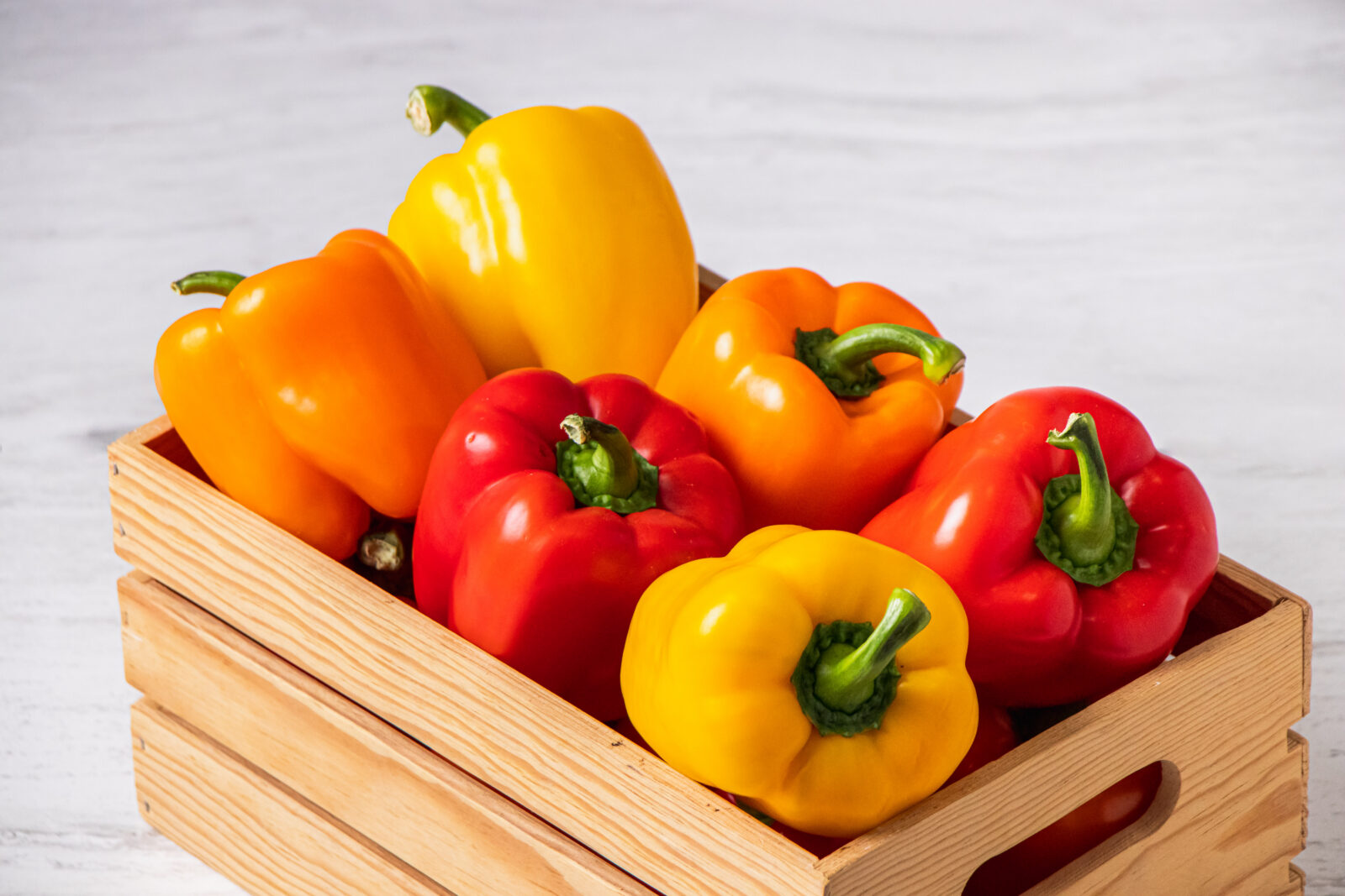 colored bell peppers in basket
