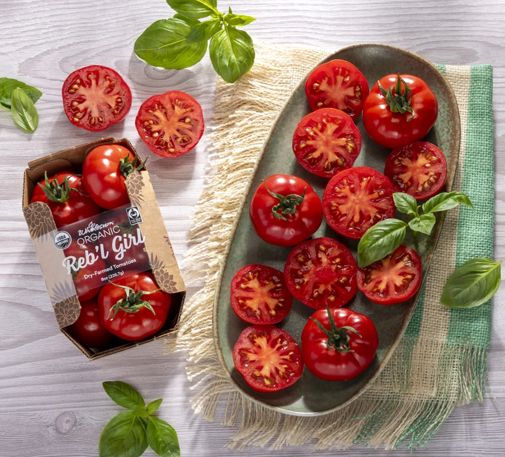 Reb'l Girl tomatoes in packaging and cut and placed on plate