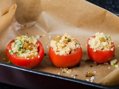 stuffed baked tomatoes with couscous. stock image.