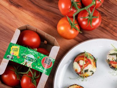 Plate of mini eggplant pizzas and fresh organic tomatoes on the vine